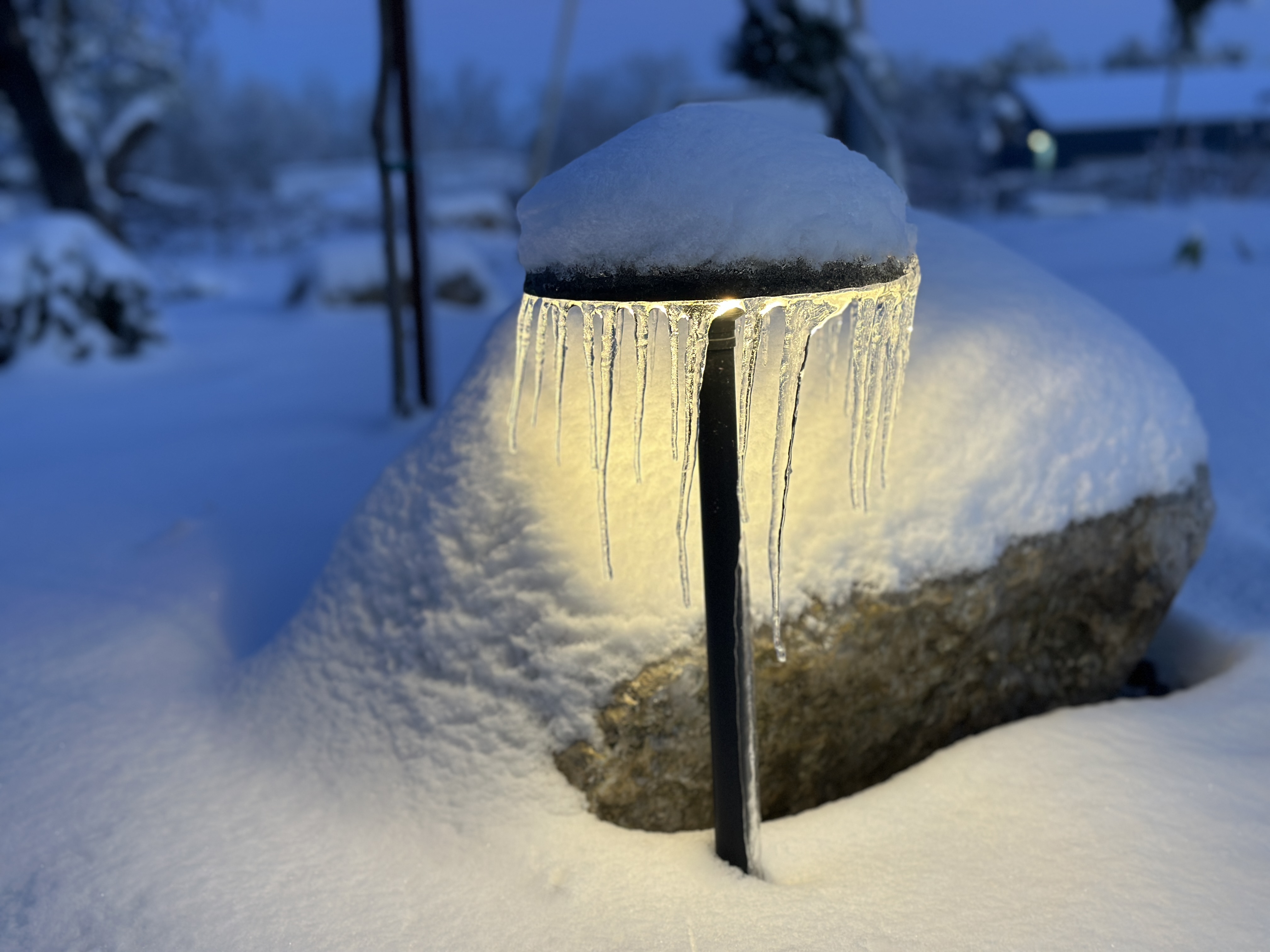Landscape lighting with icicles during blue hour in winter